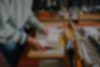 Kinder design studio, red desk, working on interior design presentations for clients in London