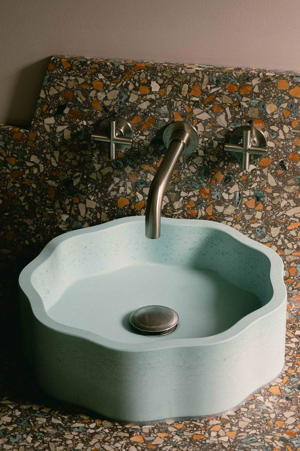 Bespoke bathroom vanity designed by Kinder Design featuring terrazzo splashback, pale blue concrete basin and brushed nickel taps