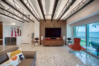 Open-concept Sarasota Condo renovation with terrazzo flooring, wood accents and modern living area