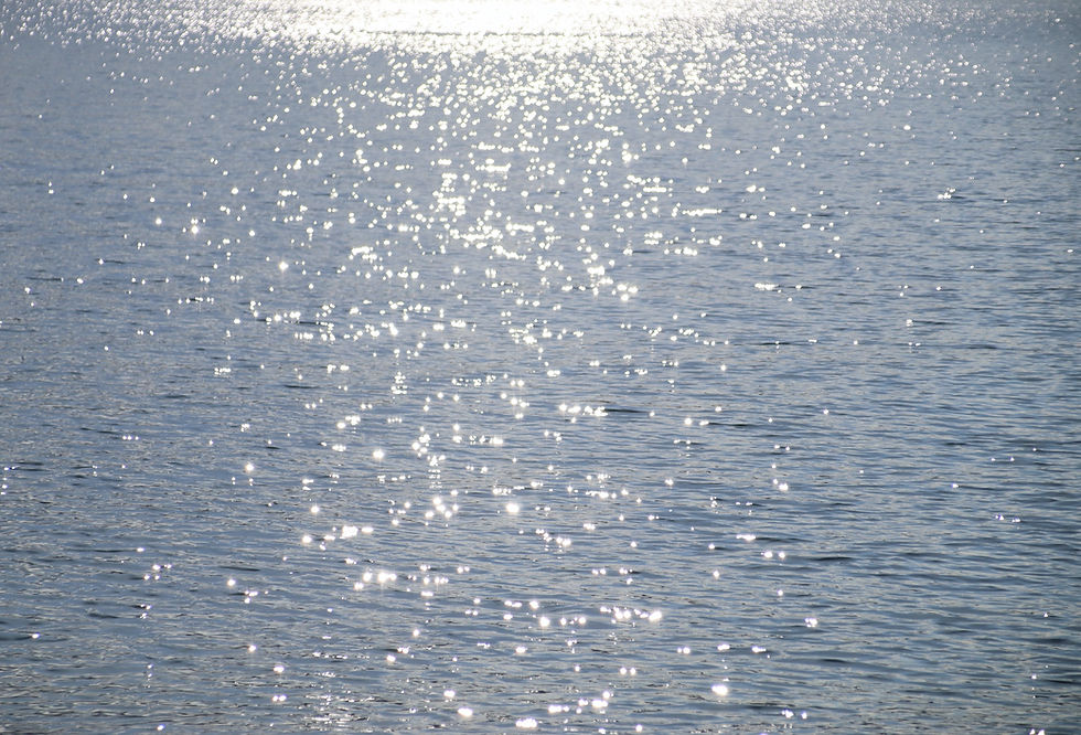 a large body of water with a boat in the distance_edited.jpg