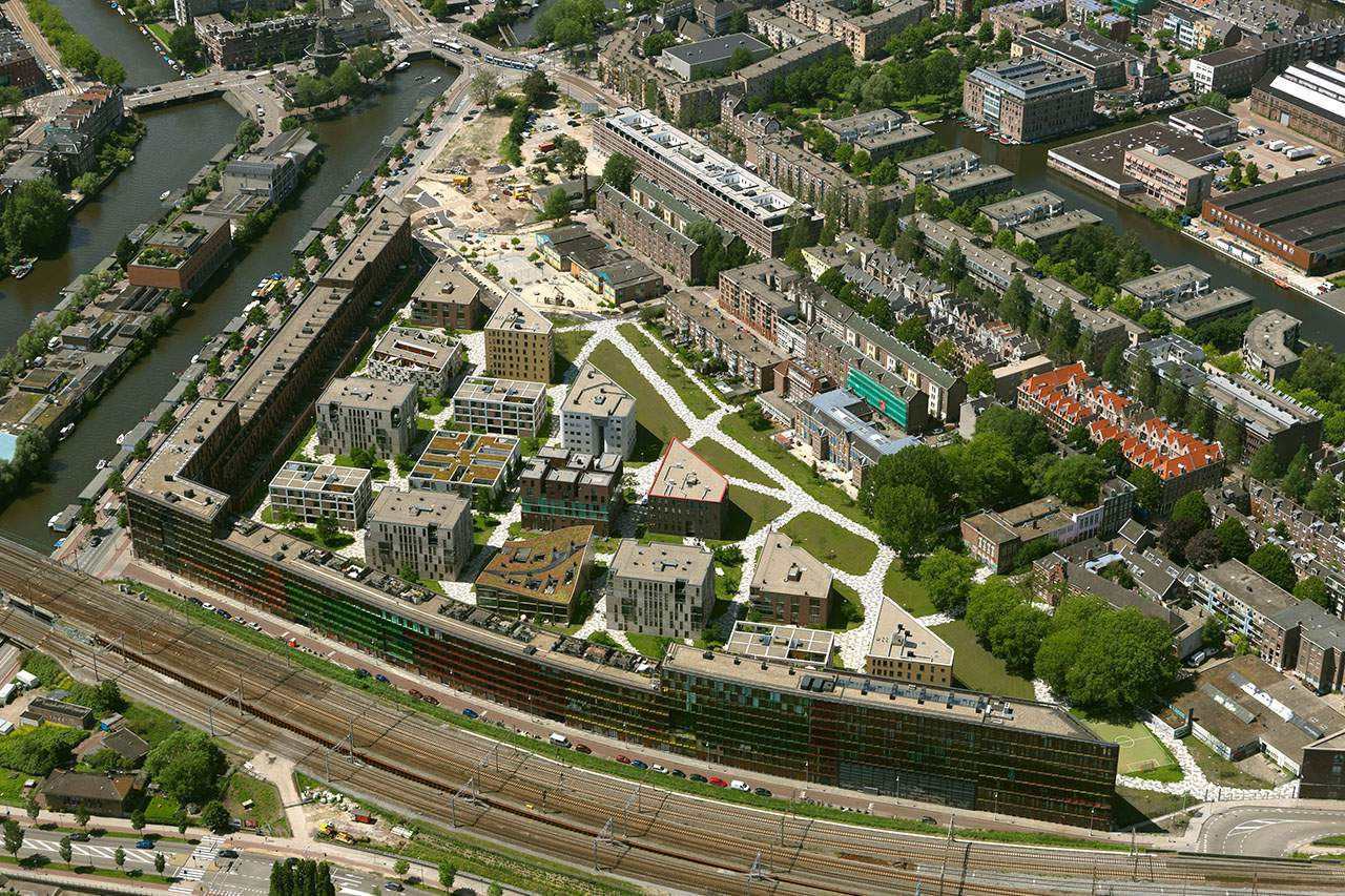 View of Funenpark, a peaceful residential area in Amsterdam featuring modern architecture, green open spaces, and tree-lined walkways. A unique blend of urban living and nature, offering a calm, community-focused atmosphere.
