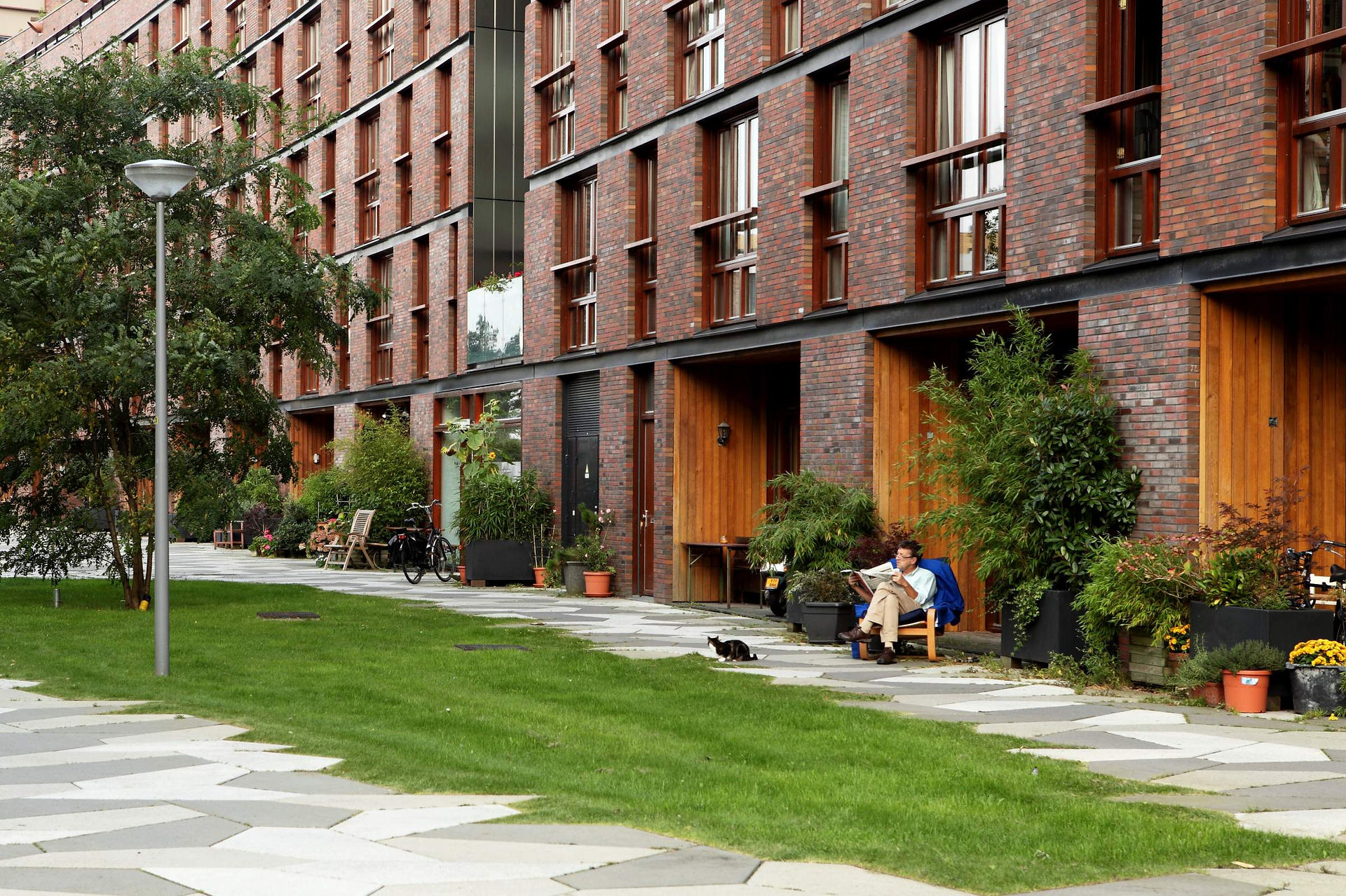 View of Funenpark, a peaceful residential area in Amsterdam featuring modern architecture, green open spaces, and tree-lined walkways. A unique blend of urban living and nature, offering a calm, community-focused atmosphere.