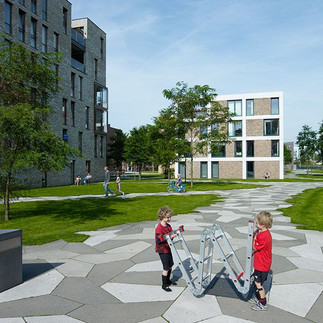 View of Funenpark, a peaceful residential area in Amsterdam featuring modern architecture, green open spaces, and tree-lined walkways. A unique blend of urban living and nature, offering a calm, community-focused atmosphere.