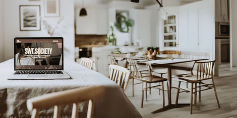 SWT Society website by WILDE Studio displayed on a laptop in a home interior