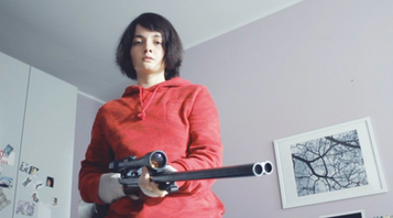 young girl with a big gun