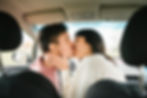 sensual couple kissing in a car