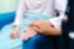 A striking close up of a nurse comforting a patient with her hand placed over the top of hers; image captured by event and pr photographer Aaron Scott Richards