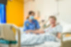 A hospice patient laughing as she chats with a nurse; captured by Birmingham PR photographer Aaron Scott Richards