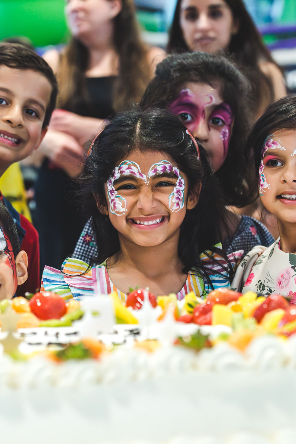 Aresha with her cousins around her birthday cake at a 5th birthday party in Halesowen
