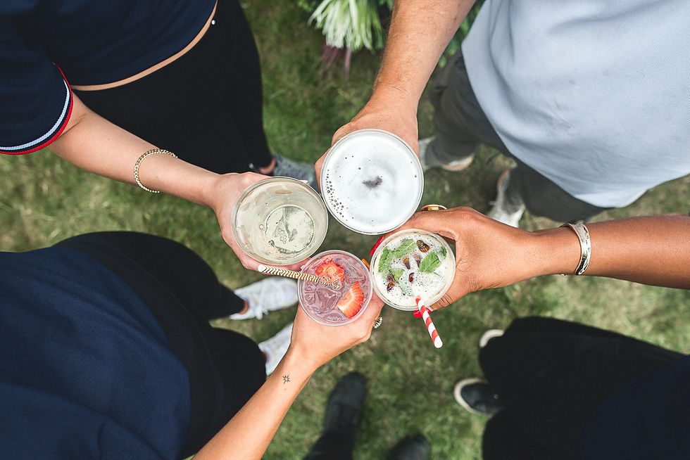 Festival visitors raising a selection of drinks together at Himley Hall