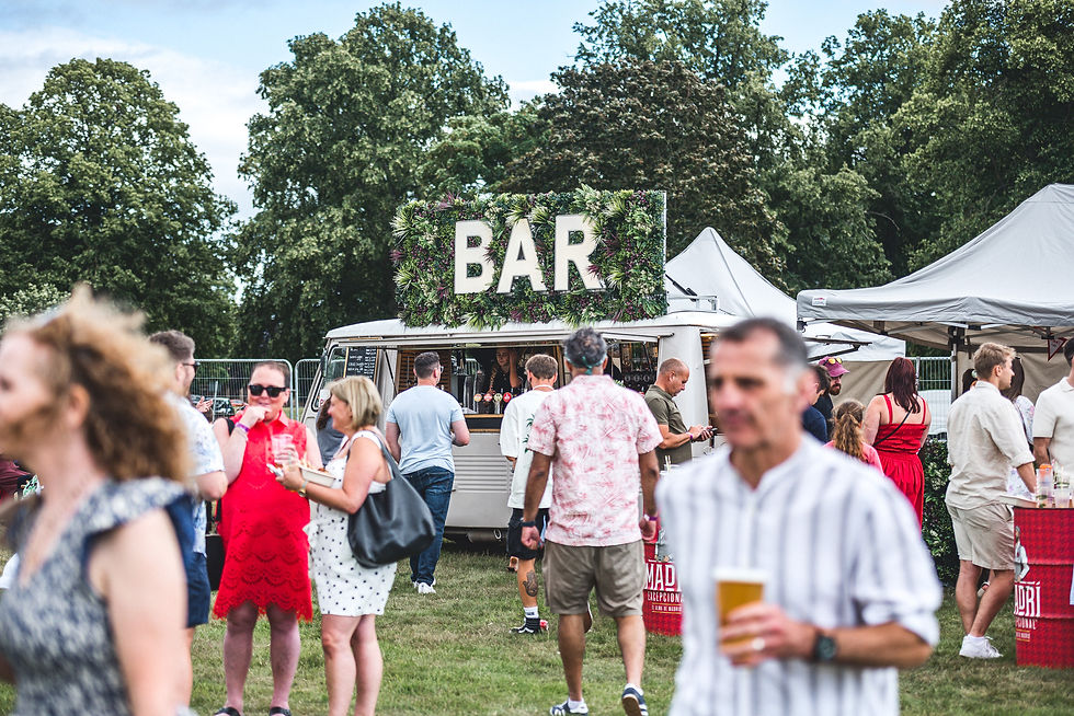 Vanderbar mobile bar surrounded by visitors at an outdoor festival at Himley Hall