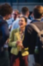 Delegates laughing during networking at Manchester conference
