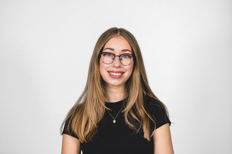 White backdrop headshot, woman with glasses