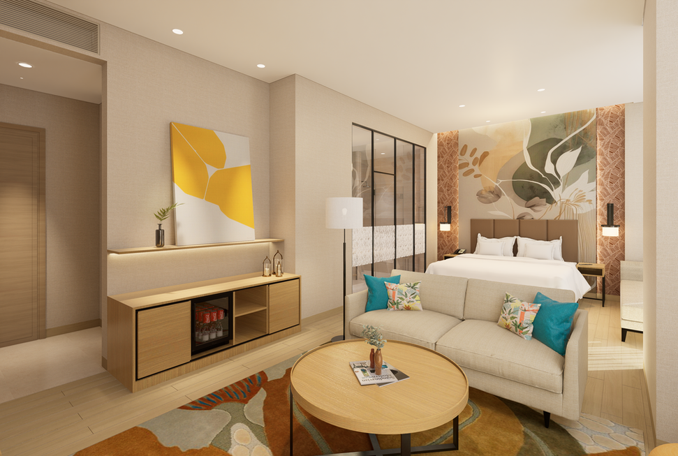 Hotel suite featuring a living area with a beige sofa, colorful rug, and a mini-fridge console, opening up to a bedroom with a large floral wall mural and a glass-enclosed bathroom.