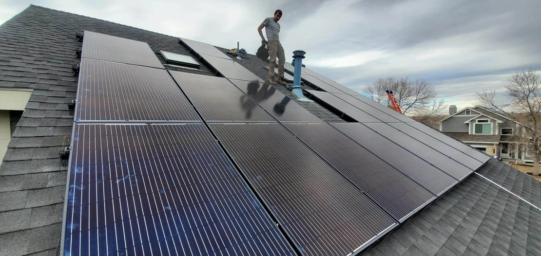 solar panel installer on residential roof 