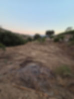 a cut out of earth in preparation for a reservoir, evening, summer, calm and peaceful