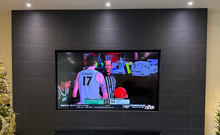 85" samsung tv mounted into a recessed tile are with an articulating tv mount