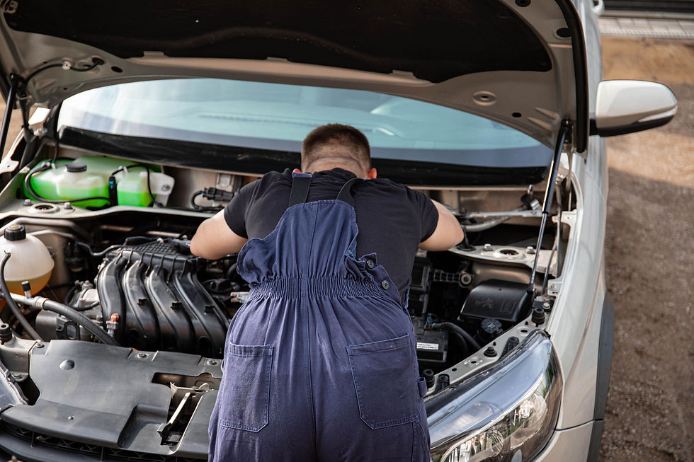 Mechanic inspecting a car outside