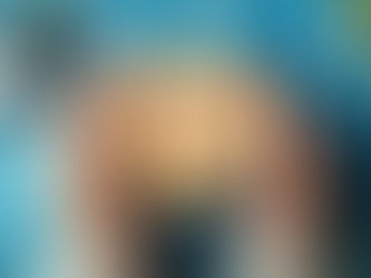 a person holding a mug with art on it that reads "2026", with a very colorful background.