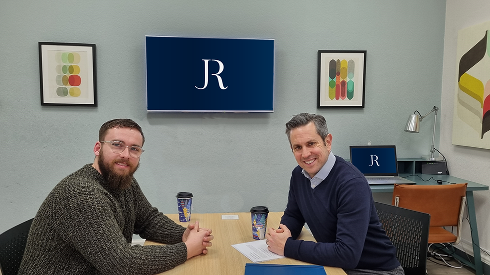 Jerome and a mentee in a conference room