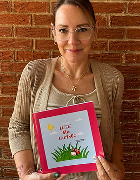 "Kristy Magee holding her book, Lizzie the Ladybug"