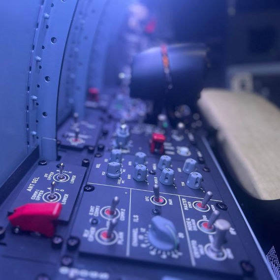 Simtek F/A-18 flight simulator control panel showing realistic switches, knobs, and backlighting