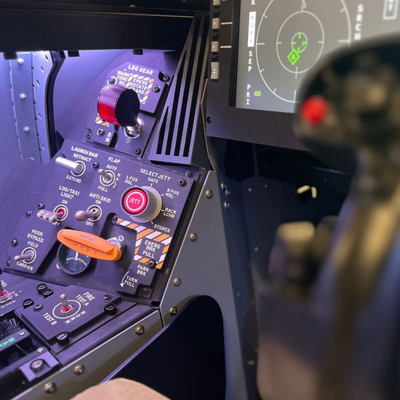 Simtek F/A-18 flight simulator control panel showing realistic switches, knobs, and backlighting