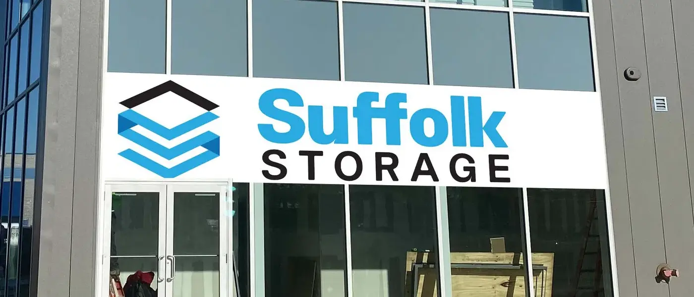 A close-up photo showing the exterior of suffolk self storage, in particular the sign that reads "Suffolk Storage". 