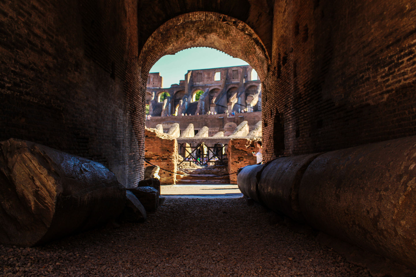 Colosseum seen through a dark archway – ancient power and mystery in Rome
