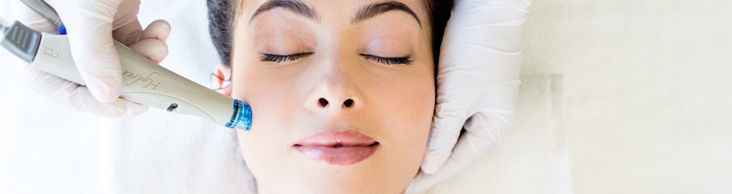 HydraFacial treatment in progress — wide banner shot