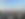 Picture of the skyline of São Paulo, Brazil. Shows various concrete buildings and mountains in the background.