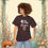 Thumbnail: woman wearing t-shirt with humorous tiktok tread berry demure, berry mindful