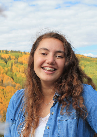 Teen multiracial Samoan female outside with fall color trees .jpg