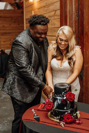 bride and groom cut wedding cake