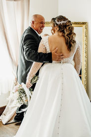 father of bride hugging bride