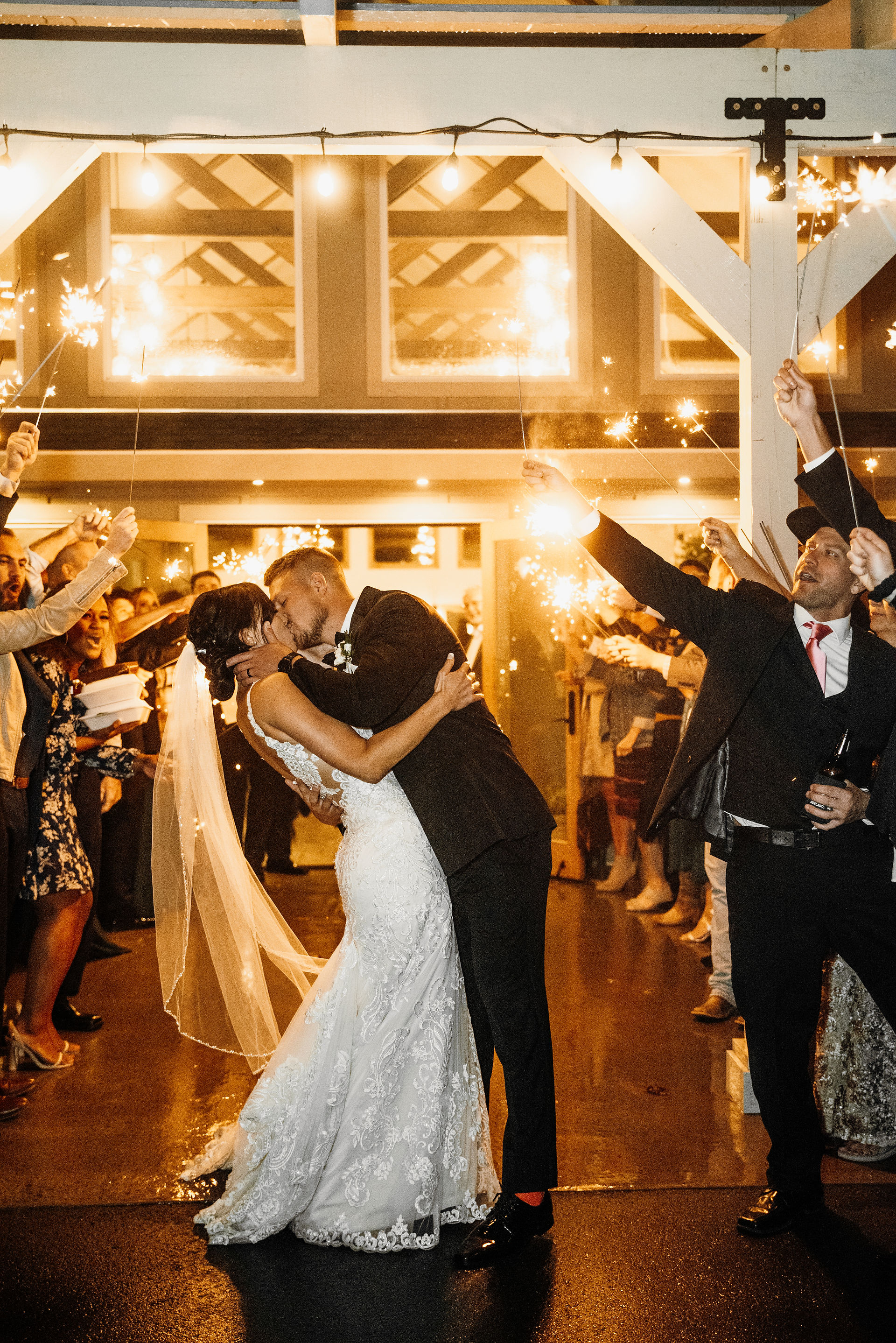 bride and groom sparkler exit kiss