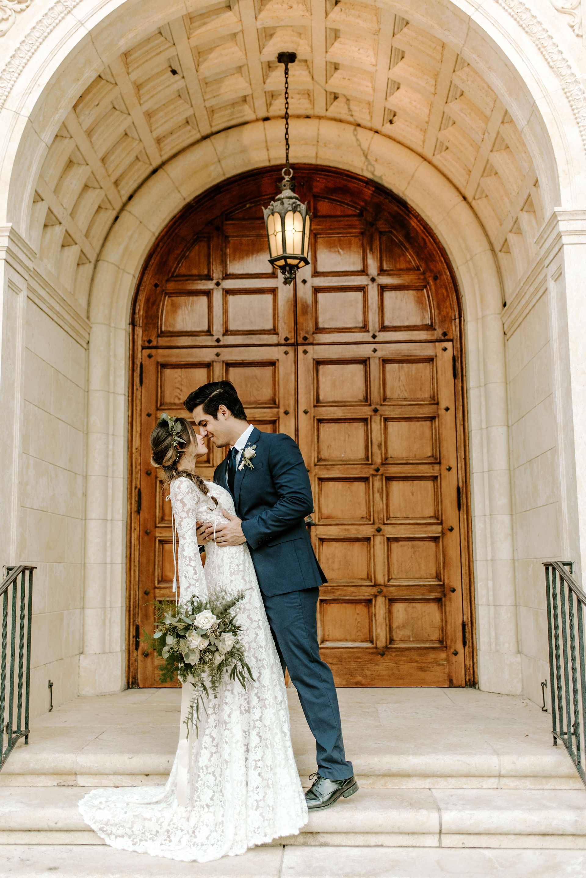 married couple in front of church doors