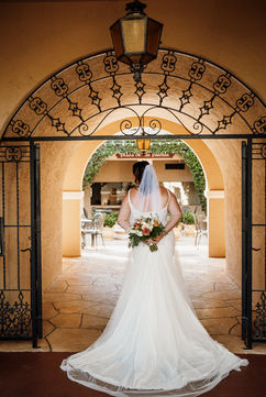 back of bridal gown with bouquet