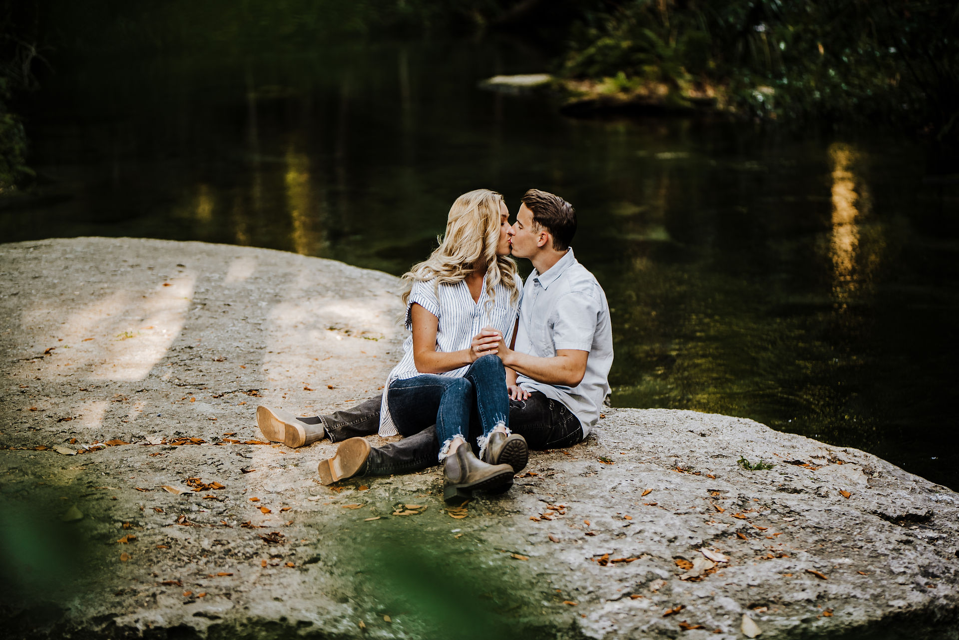 engagement kissing on rock