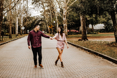engaged couple hold hands