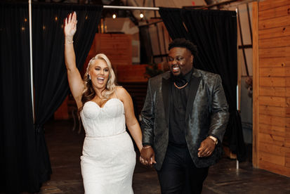 bride and groom walk into reception