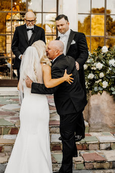 father kissing bride