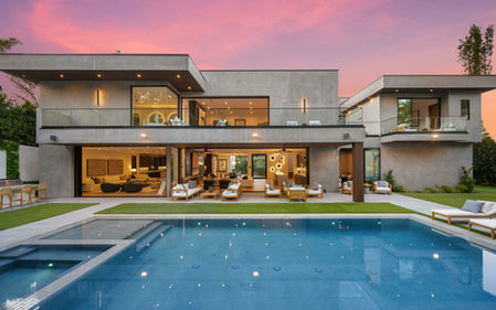 a large modern house with a swimming pool and patio