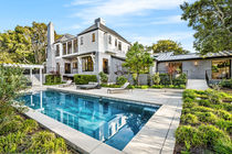 a large house with a large swimming pool in front of it