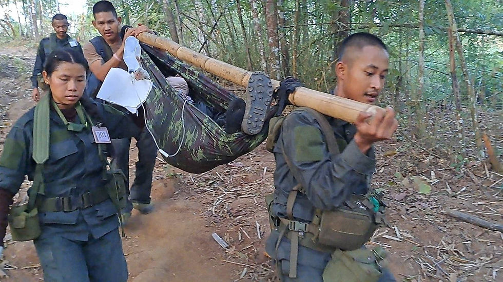 RTC joins other Rangers in carrying a simulated casualty during medical training.