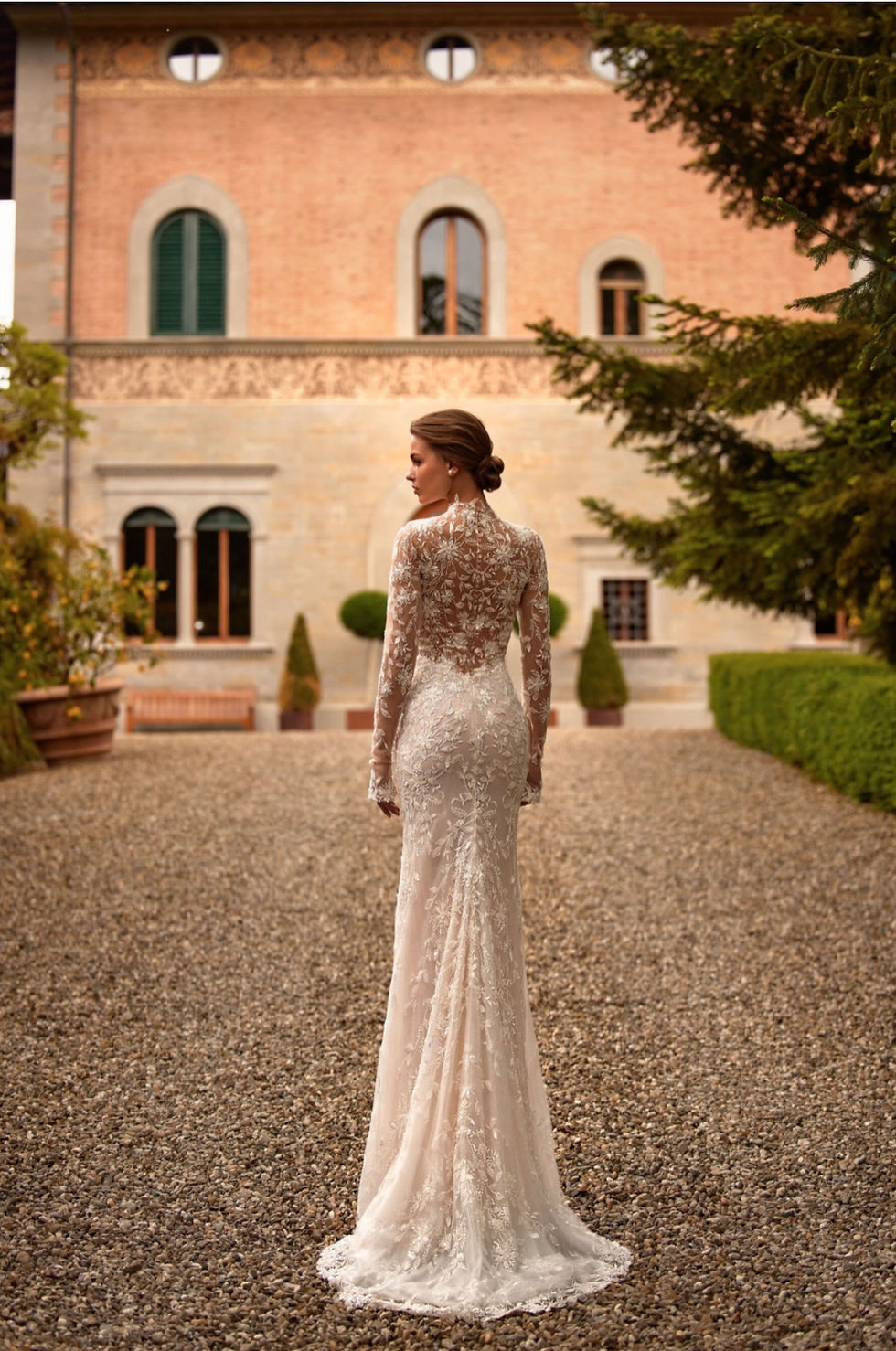 Thumbnail: Bride wearing a romantic A-line wedding dress with floral details