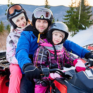 Family riding on an four-wheeler/atv
