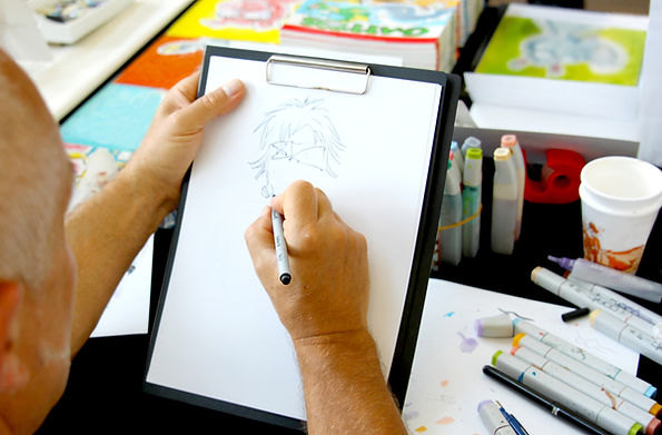 Anime artist in Manchester sketching an Anime design Manchester 2021 AR Anime & Comic Studios
