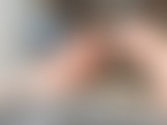 A person making a furnace repair with a screwdriver. The image focuses on hands working amidst pipes and metal parts. The setting is indoor.