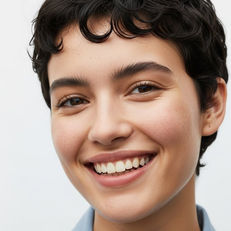 Smiling woman in blue shirt with The Touselled Wavy Hair Routine best wavy hair routine